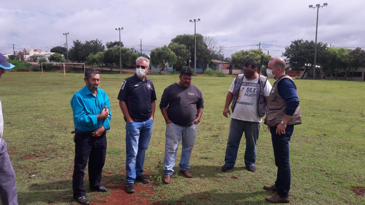 Santello (2º a partir da esq.) e Macanhão (1º à dir.) conversam com os moradores sobre o campinho de futebol